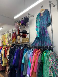 inside of a shop showing colour vintage clothes
