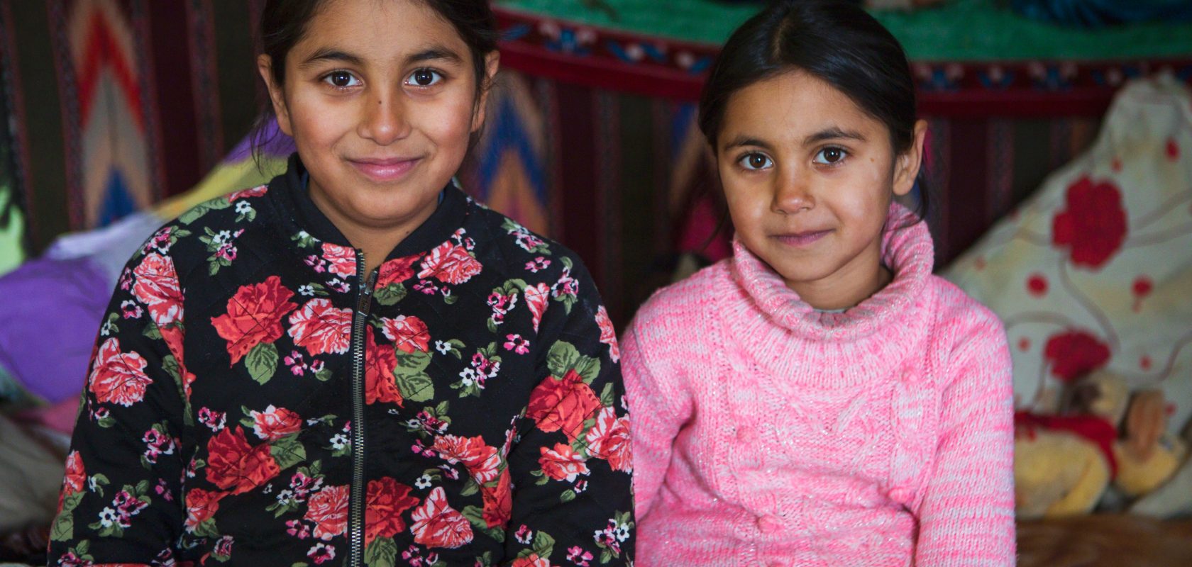 Sisters sitting in their home in northern Romania