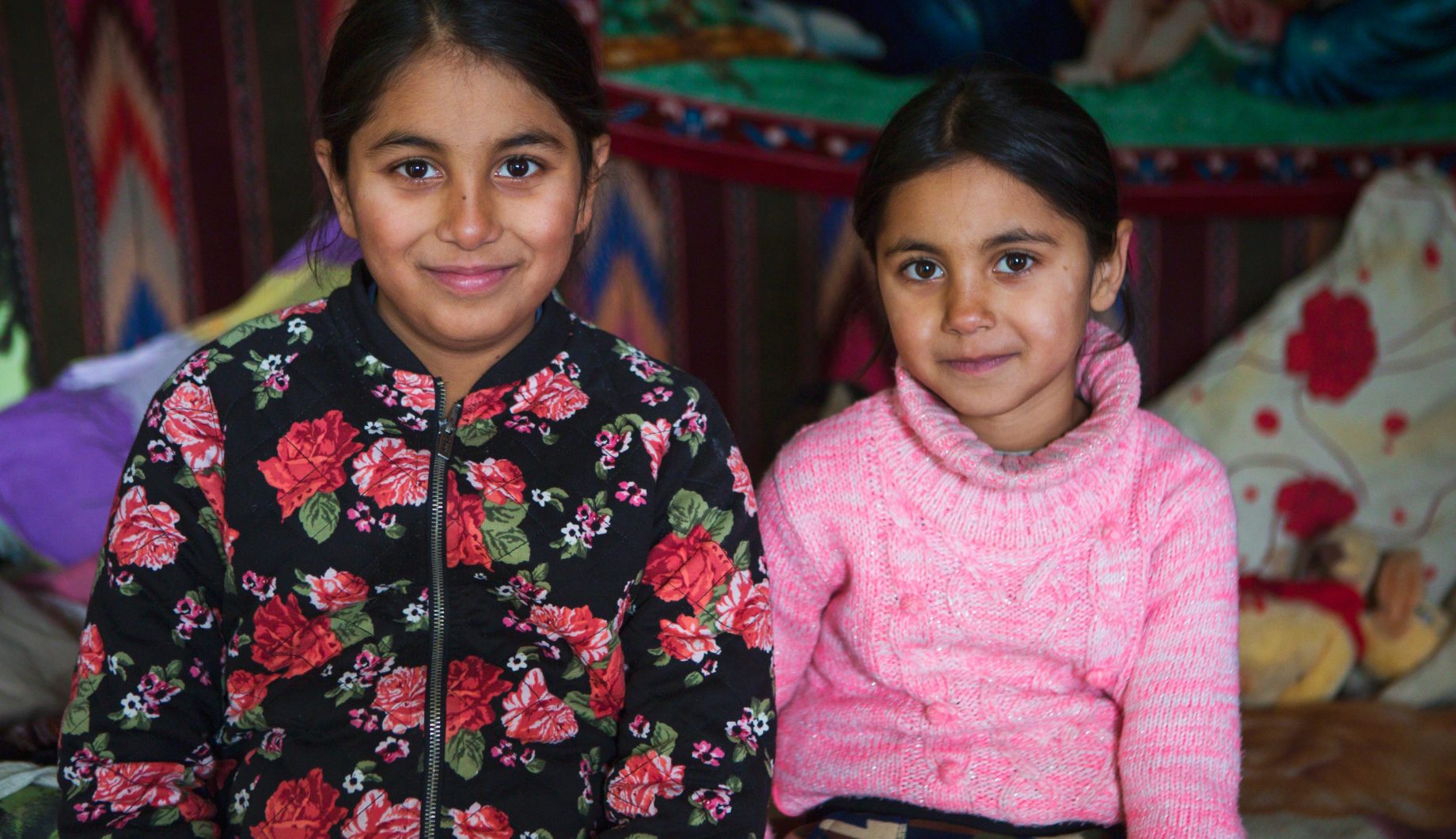 Sisters sitting in their home in Northern Romania