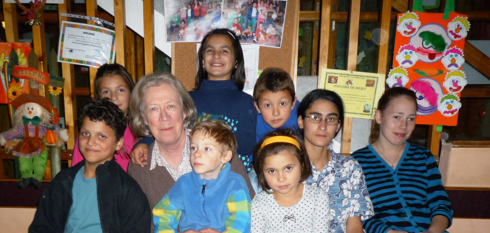 FARA Charity FOunder Jane Nicholson sits surrounded by Romanian children